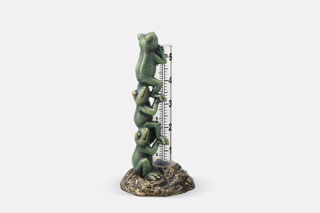 Decorative thermometer with frog design on a white background