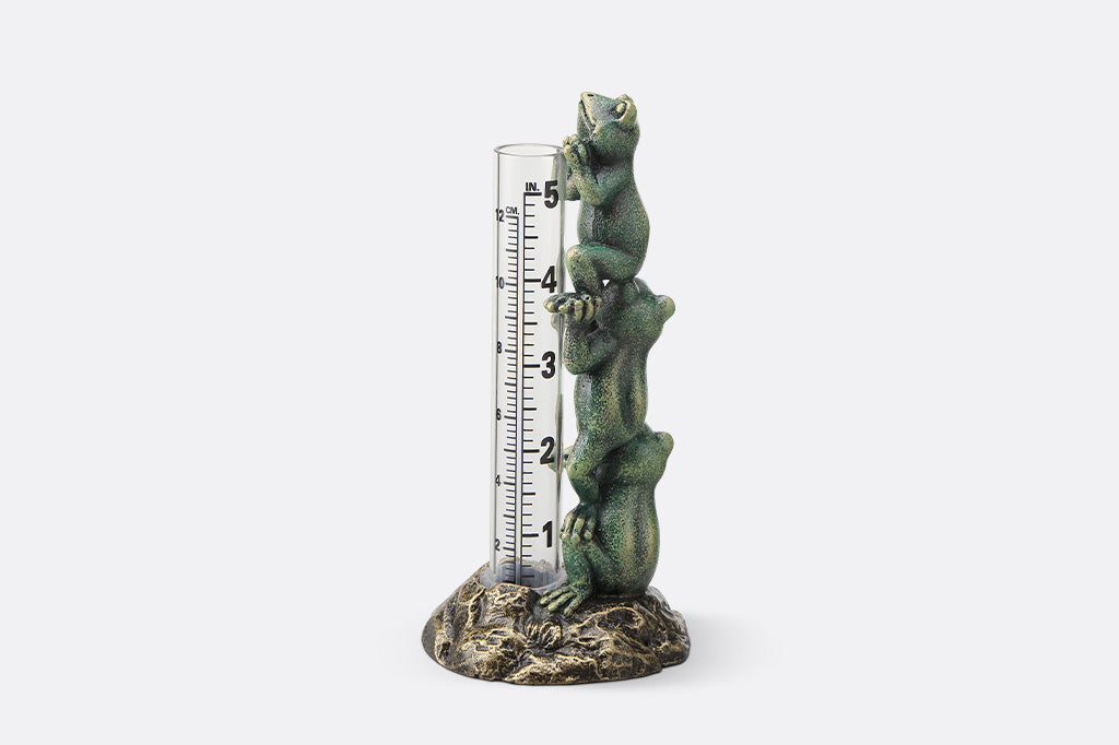 Decorative thermometer with frog design on a white background