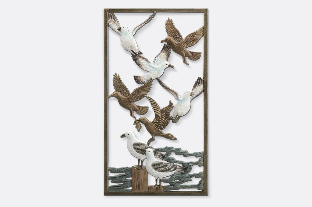 Decorative wall art with metal birds on a white background