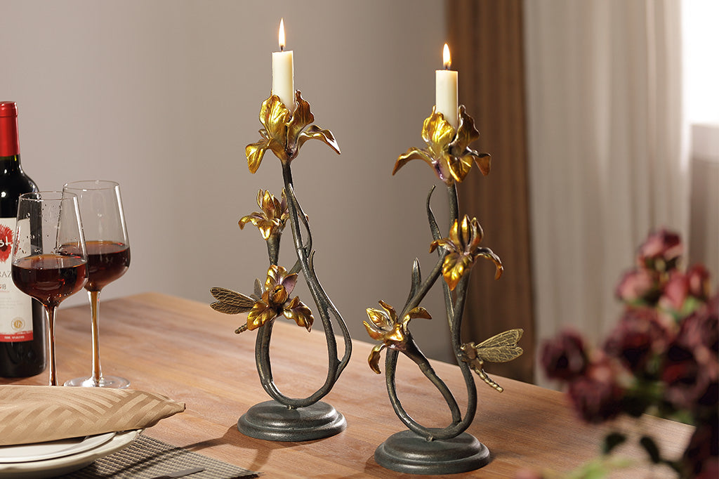 A pair of taper candleholders shaped like iris flowers with a dragonfly.