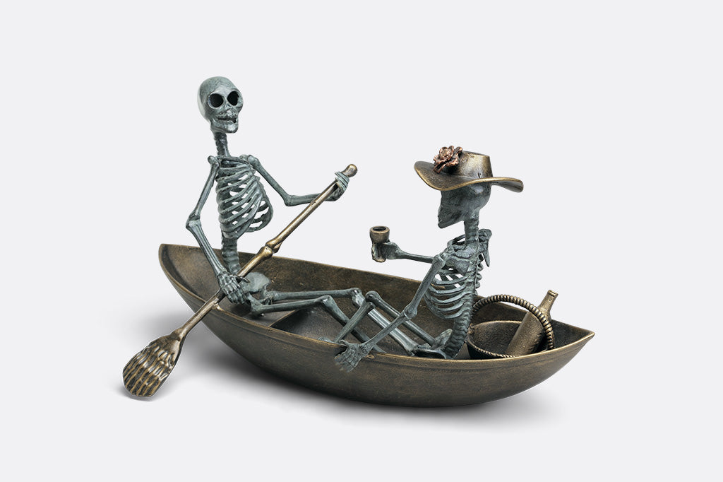 Two skeletons in a boat with one rowing and the other sitting, on a white background