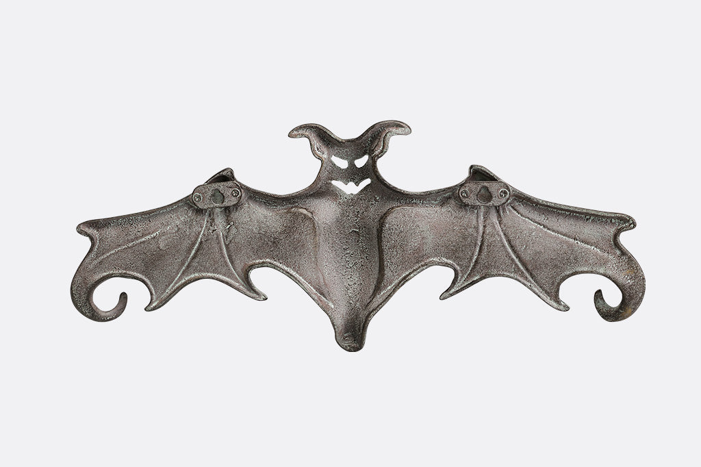 Metallic bat-shaped object on a white background