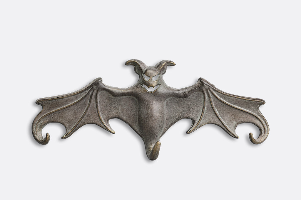 Metallic bat-shaped object on a white background