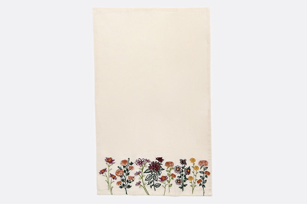 One towel with detailed images of flowers along it's bottom side.