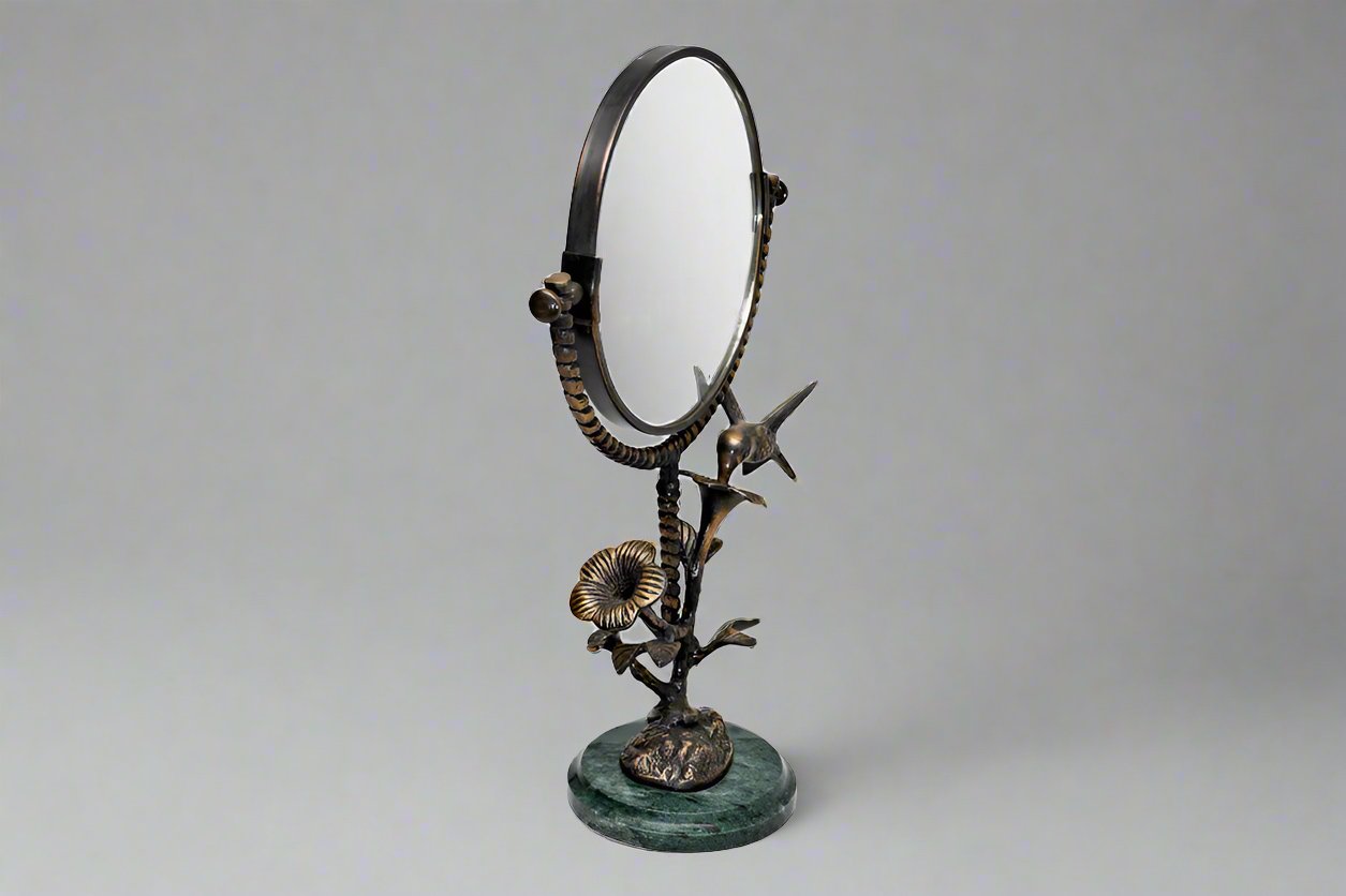 vanity mirror with marble base and stem of blossom and hummingbird motif