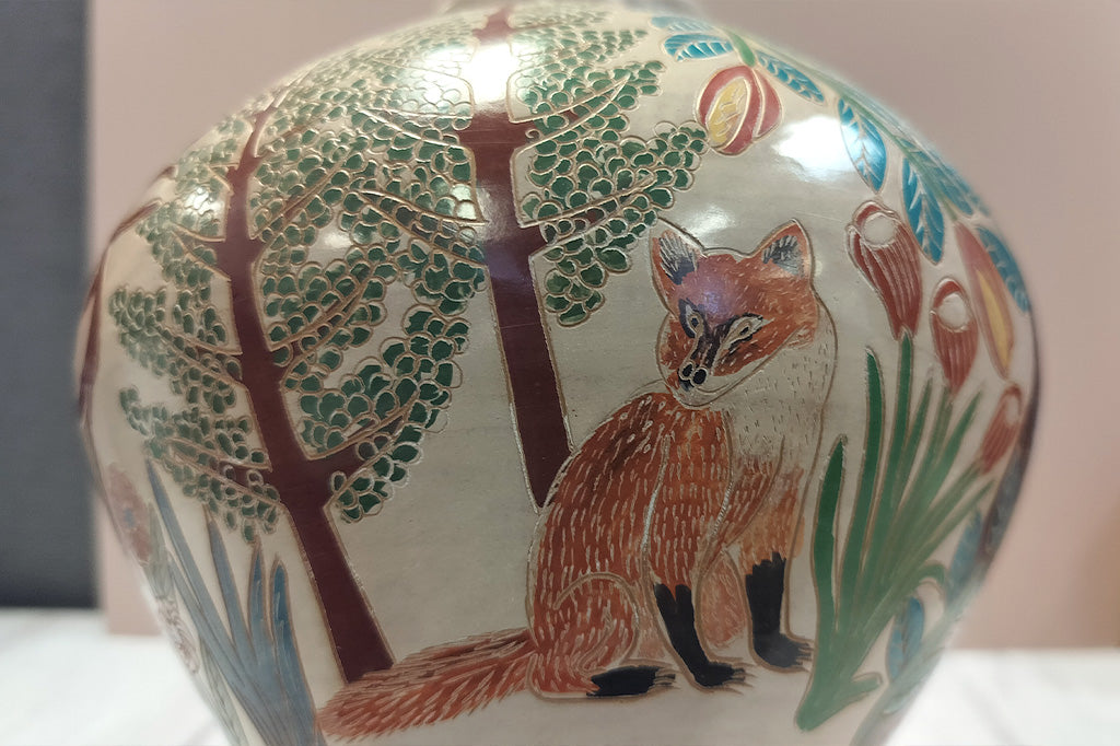 Close up view of fox design on the hand-etched wood fired clay pottery, Fair Trade from Nicaragua featuring forest animals