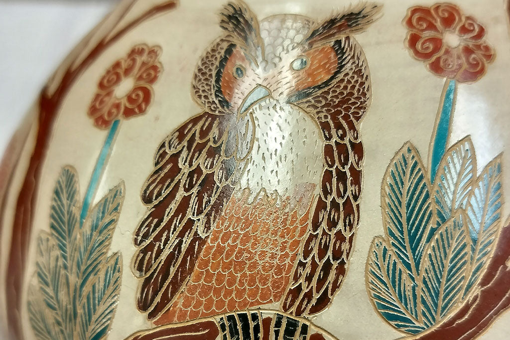 Close up view of owl design on the hand-etched wood fired clay pottery, Fair Trade from Nicaragua featuring forest animals