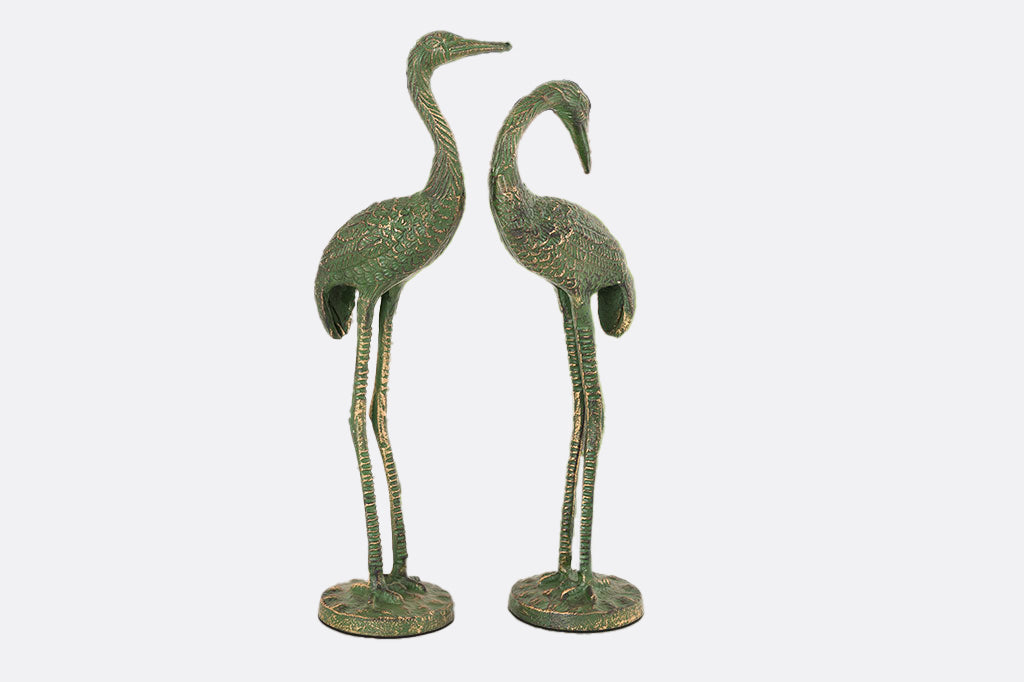 metal cranes with mossy green patina 