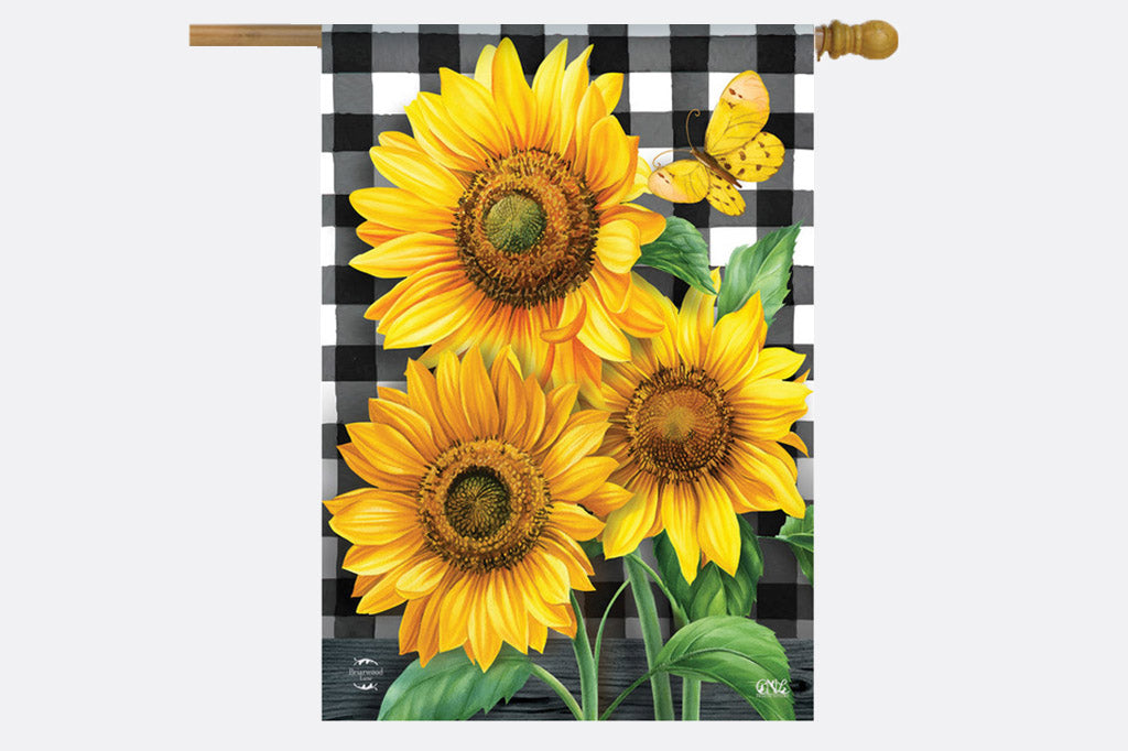 garden flag of sunflowers and black and white buffalo checked background shown on wood flag pole