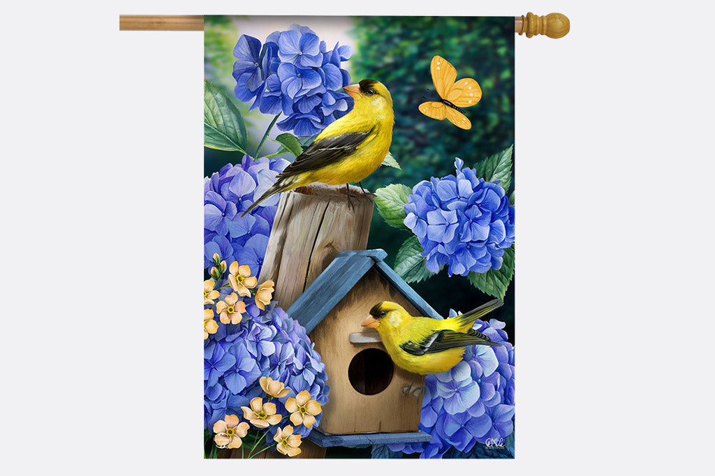 garden flag design of goldfinches and hydrangeas -shown on wooden flag pole