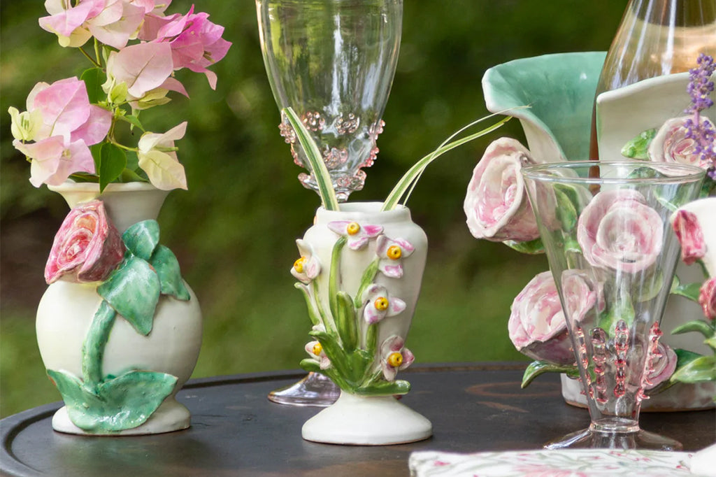 floral vase set on outdoor dining table holding fresh flowers