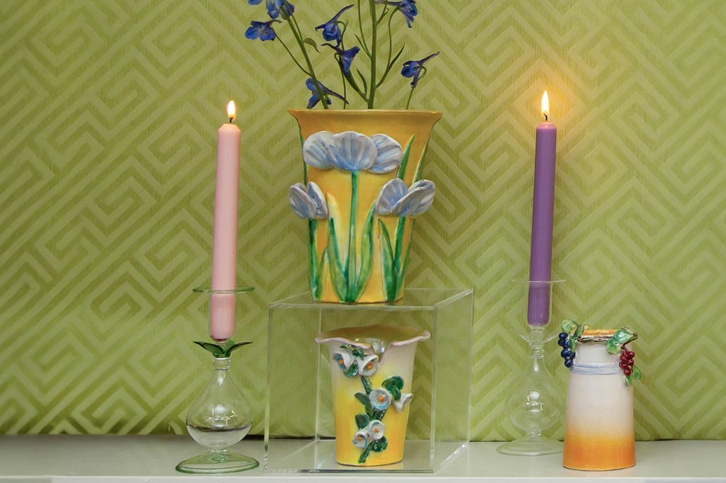 floral vase set in trio on table filled with live irises 