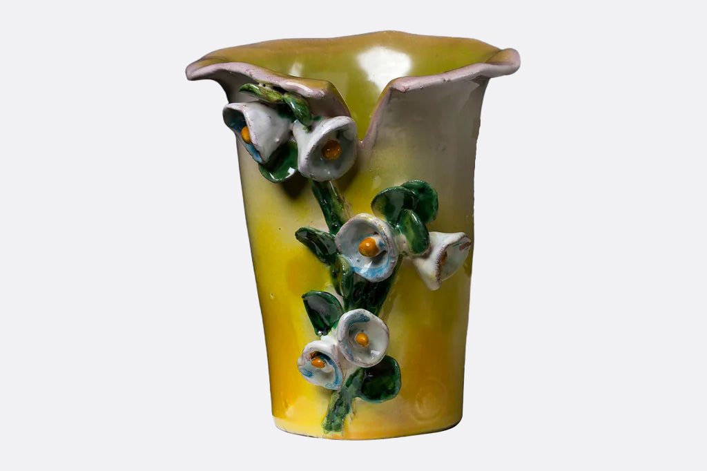 mango colored vase with 3-d flower clusters on front of vase 