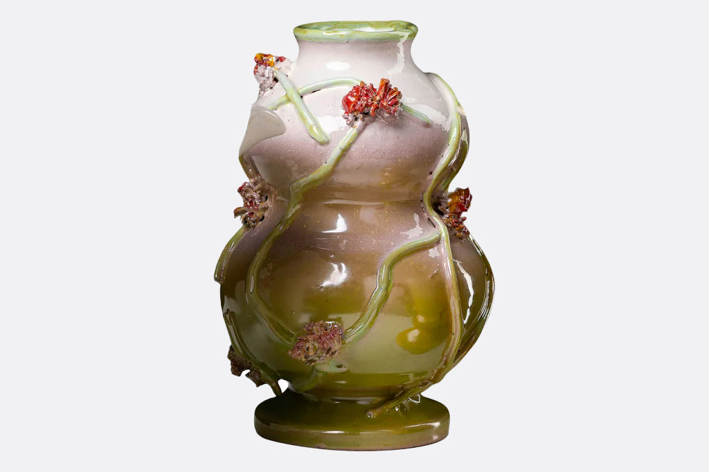 irregular shaped vase with 3-d sculpted floral design 