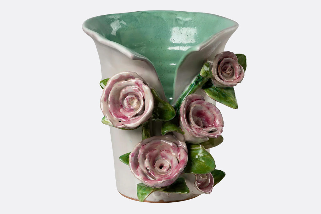 ceramic vase with 3-d sculptured pink roses on front with aqua blue interior cream exterior 