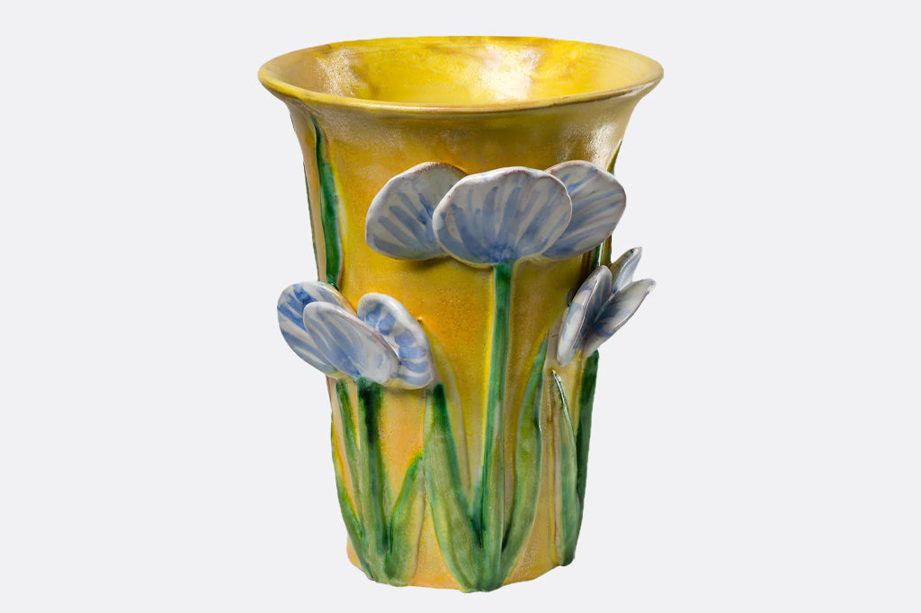 blue 3-d sculpture flowers on mango colored wide neck ceramic vase
