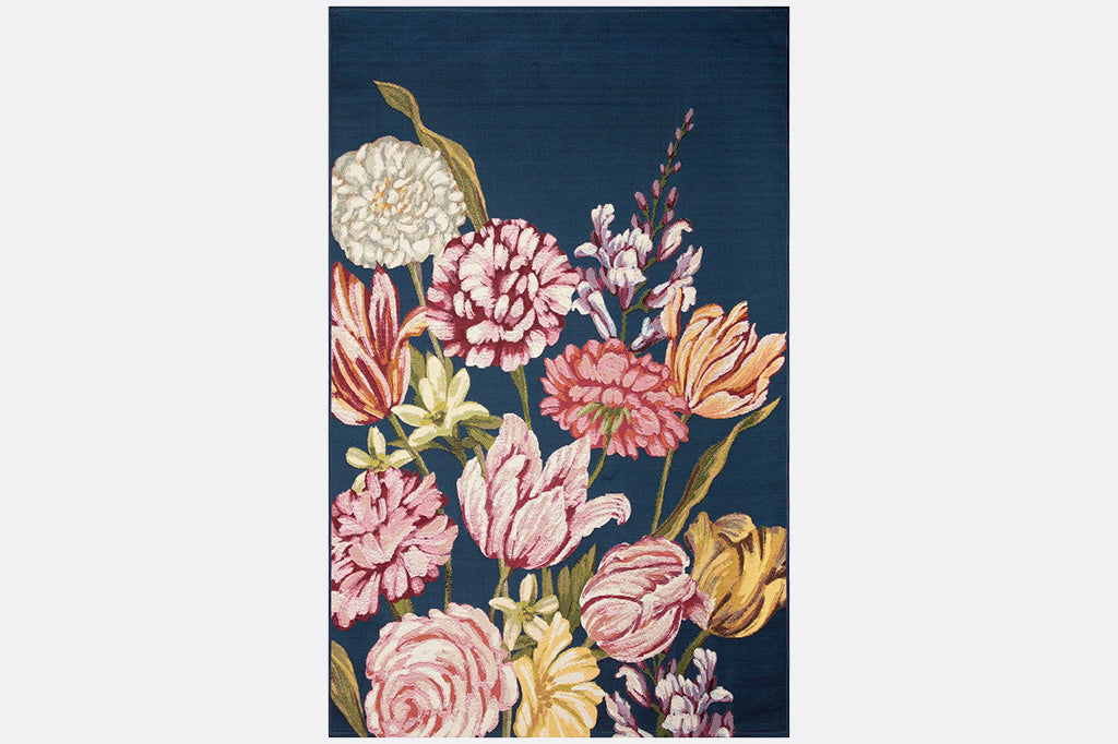 Floral patterned low-nap rug with pink, yellow, and white flowers on a dark blue background