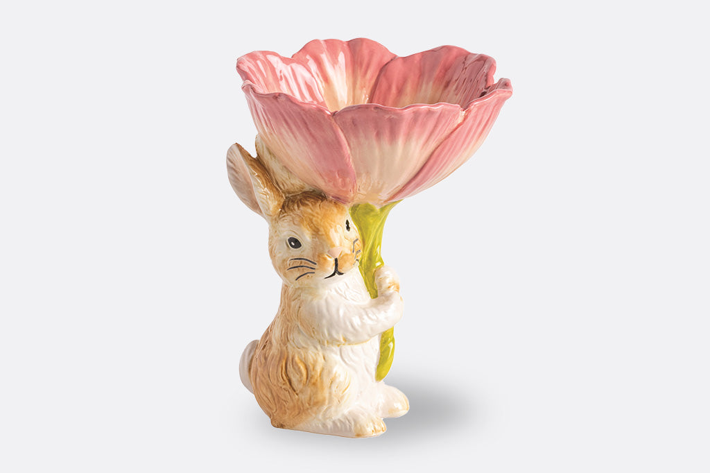 A bunny holding a bowl shaped like a flower