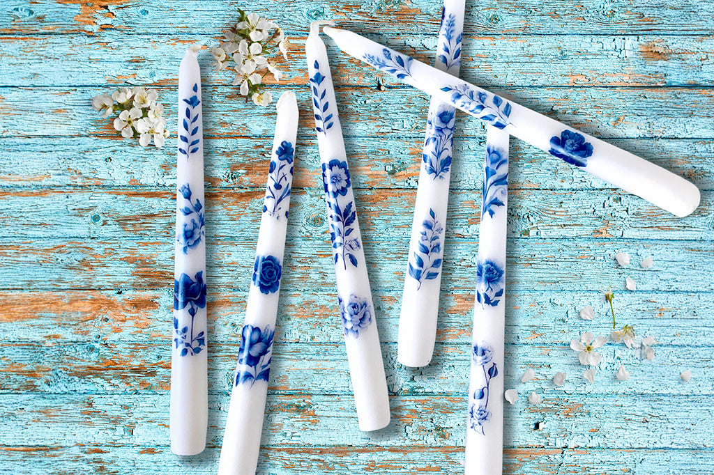 blue and white floral taper candles on blue background