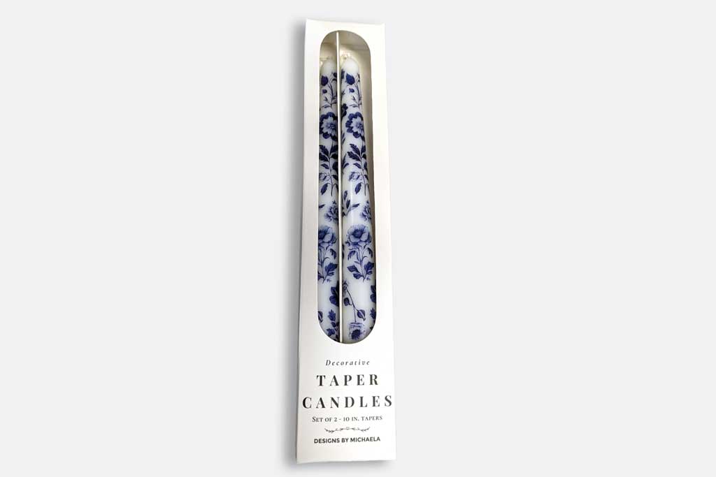 Taper candles with its packaging on a white background