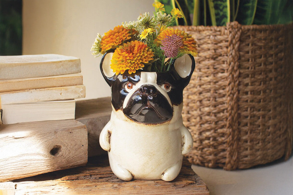 A vase shaped like a  dark brown and tan pug.