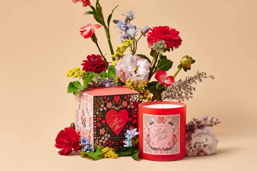 Candle and decorative box and candle with floral arrangement on a beige background