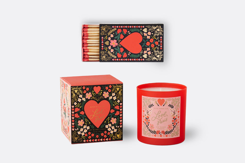 Decorative candle and matchbox set with floral and heart designs on a white background