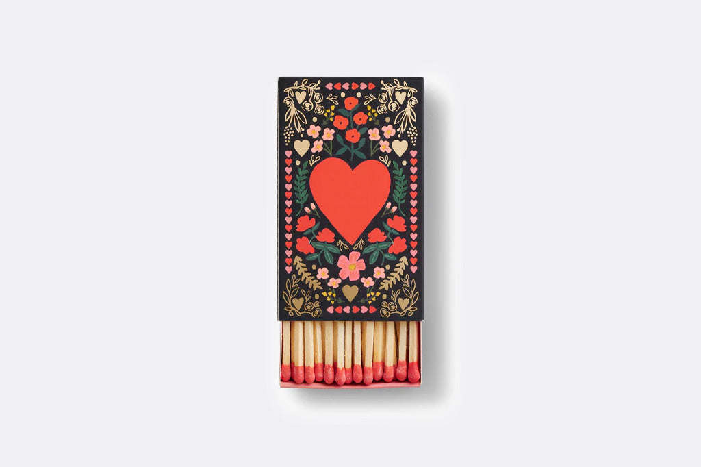 Matches with decorative packaging featuring a heart design on a white background