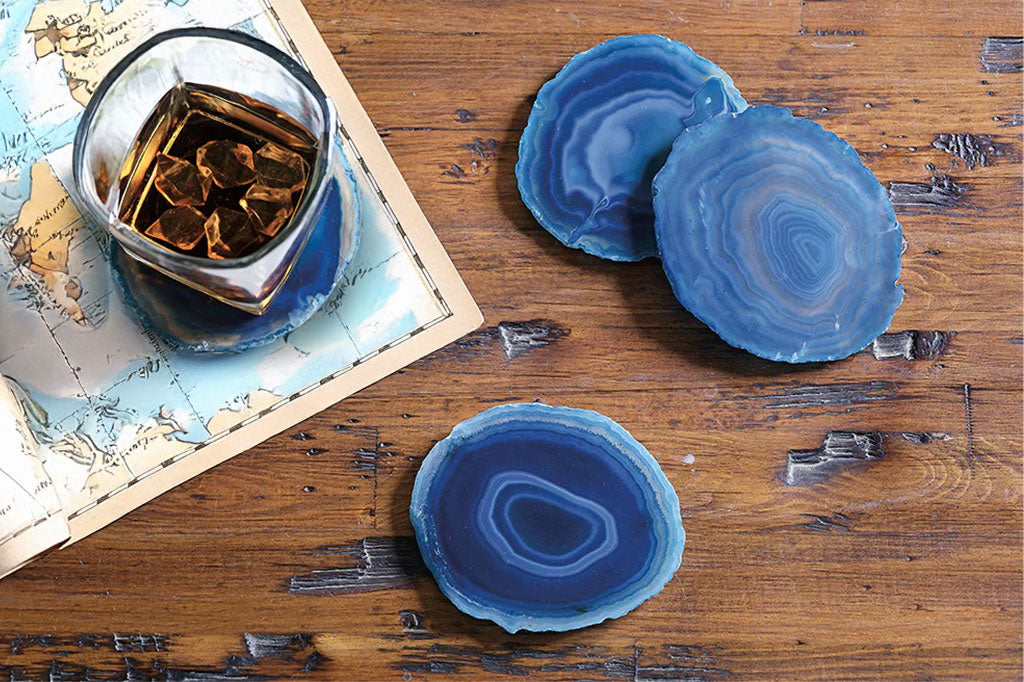Set of four blue crystal coasters set on table #color_teal
