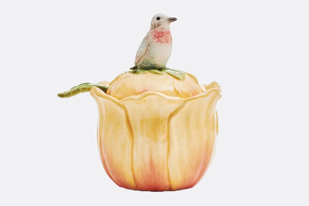 Ceramic yellow blossom shaped condiment container with a charming bird perched on top. The leaf-shaped spoon adds a whimsical touch and makes serving your favorite condiments a breeze.