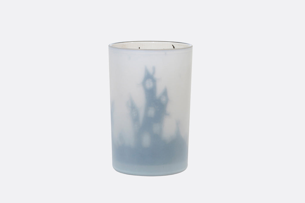 Frosted glass candle holder with a blurred landscape design on a white background