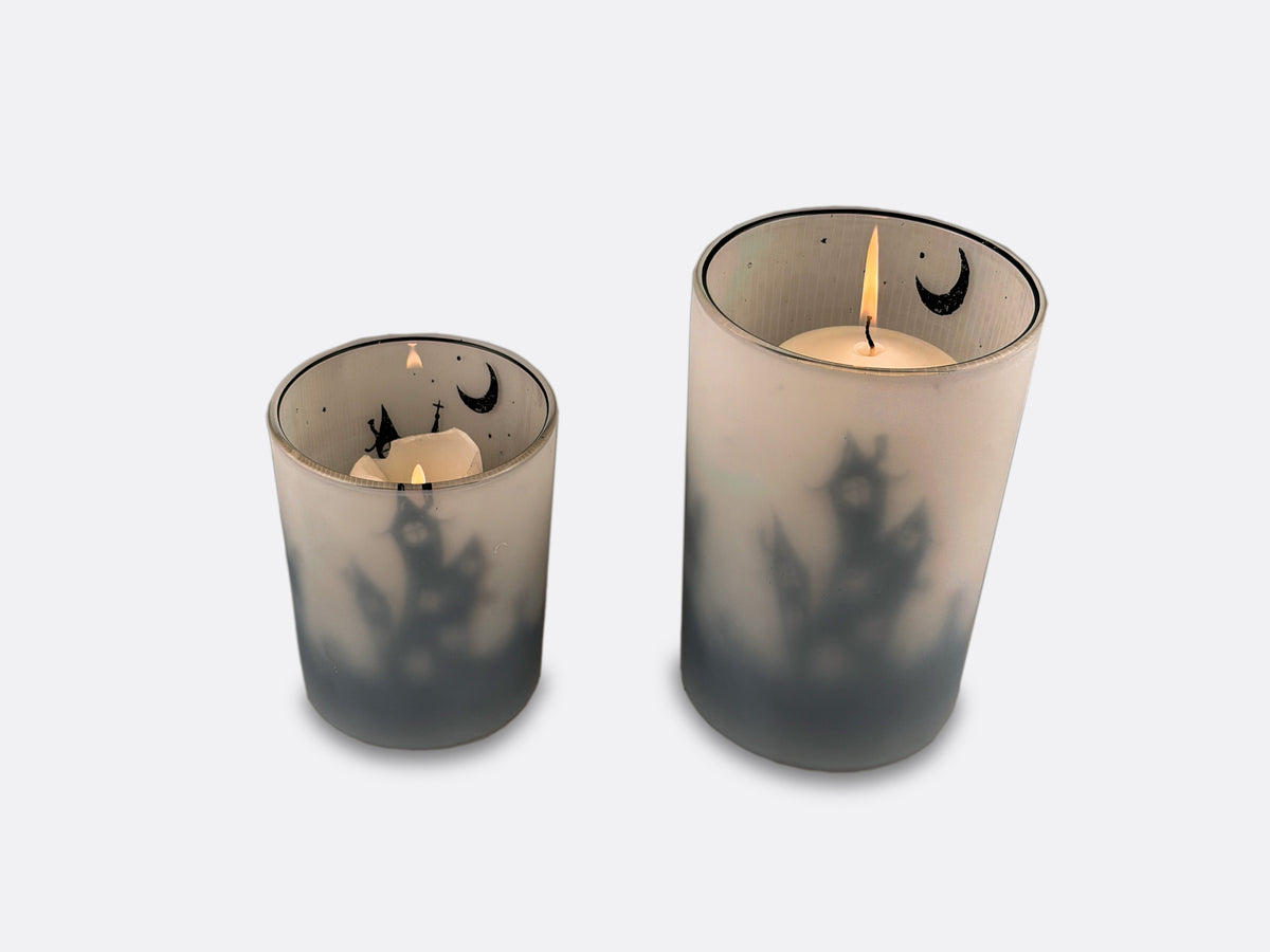 Two Halloween themed candle holders.