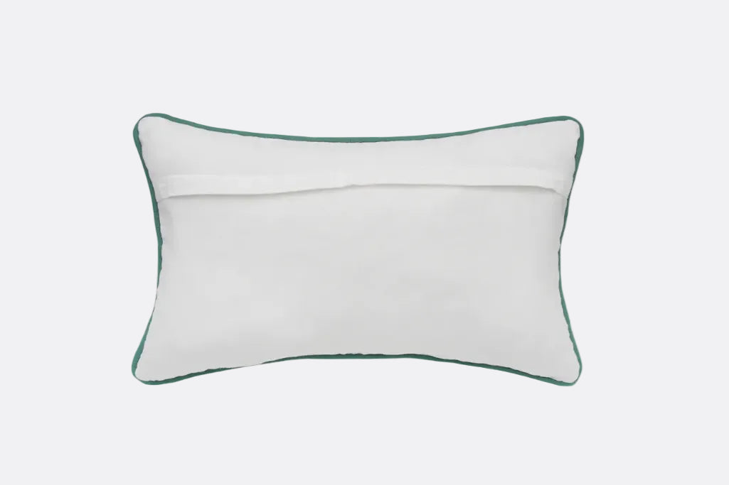 A rectangular white lumbar pillow with a contrasting dark green piped border, shown from the back on a solid white background.