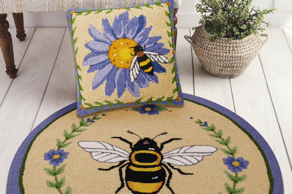 Honey Bee Mine hooked rug and pillow shown on floor in a room