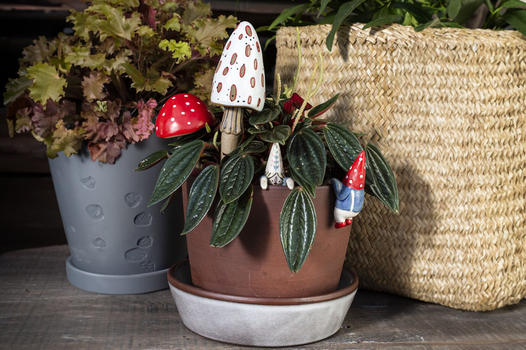 pair of red and white mushroom planter stakes