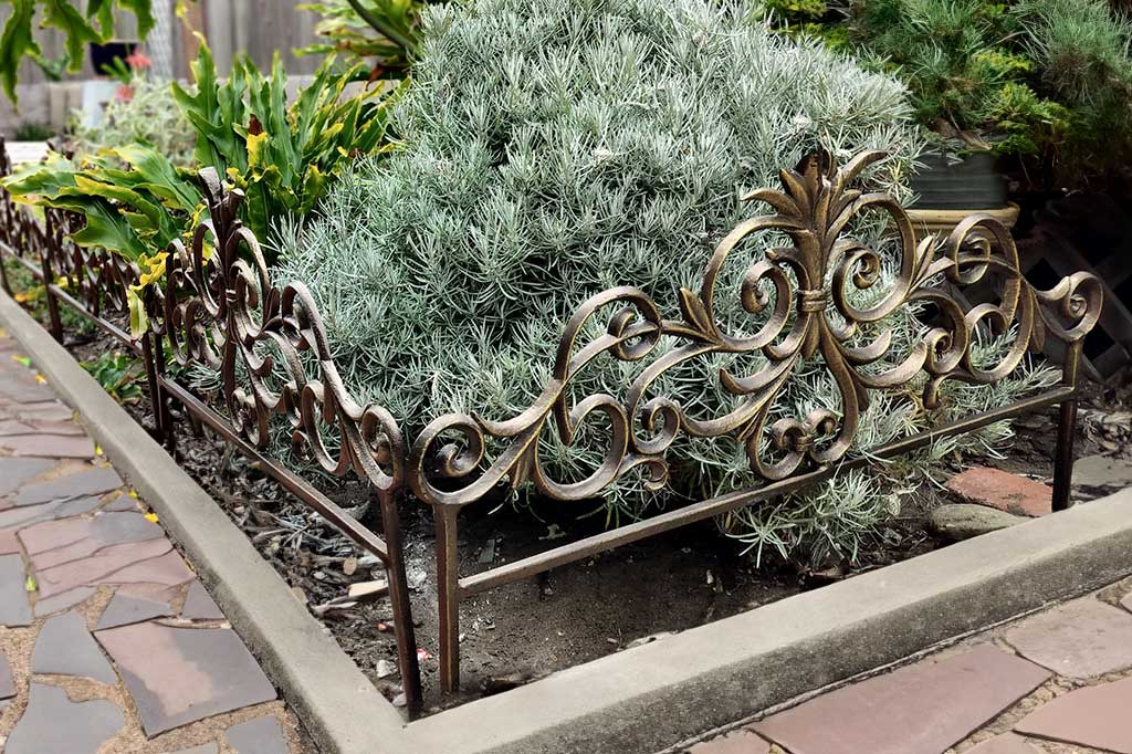 4 sections of Allora Garden Edging shown next to a slate path in a yard