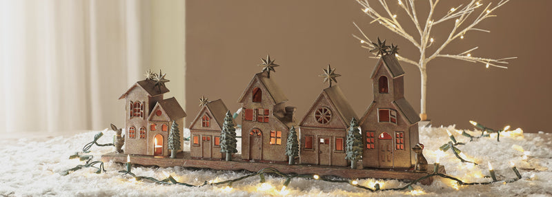 video of Christmas village theme candle holder, houses are changing place in the scene in interchangeable places