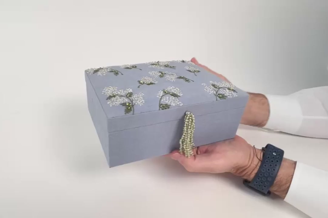 video showing the detail work and interior of embroidered pastel blue jewelry box with beaded tassel