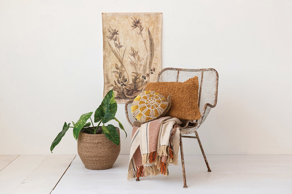 yellow and brown snail shaped pillow placed on chair in living room scene 