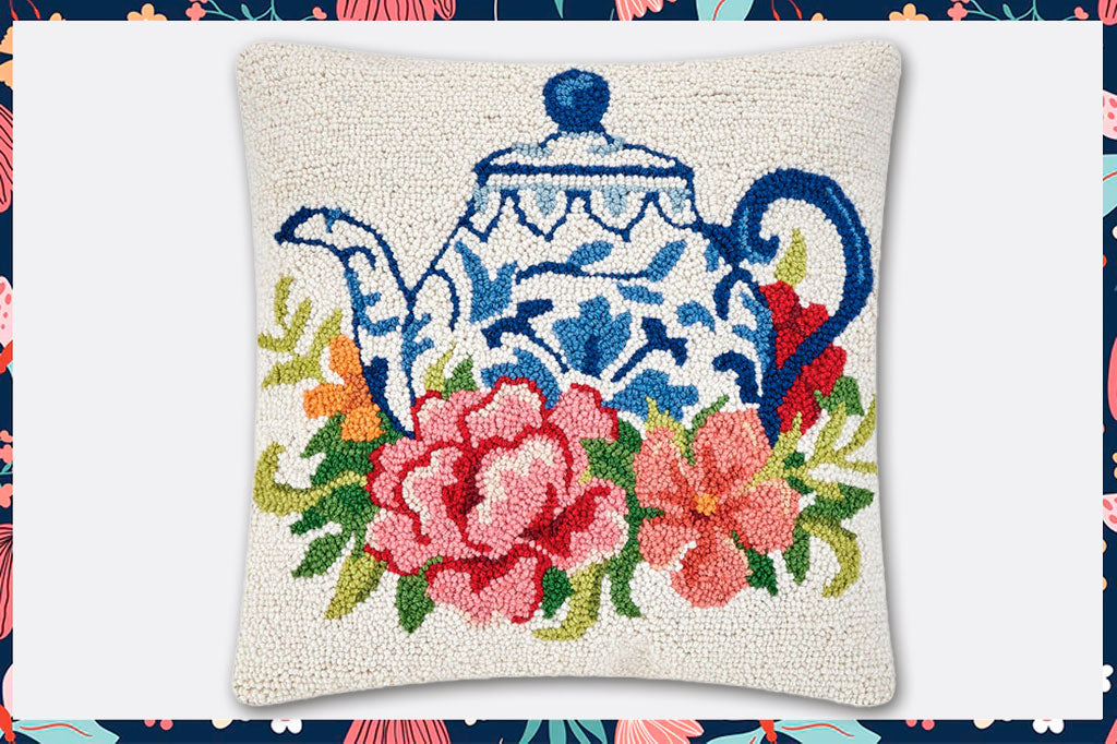 blue and white teapot with pink blossoms motif on hooked wool pillow 