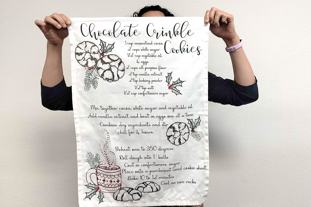 Cookie Recipe tea towel held up in front of a person