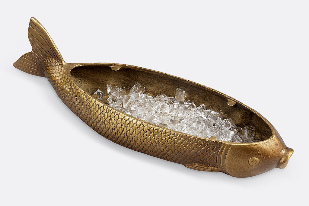 Cast metal serving tray shaped like a fish, shown without it's glass topper to reveal a reservoir filled with ice.