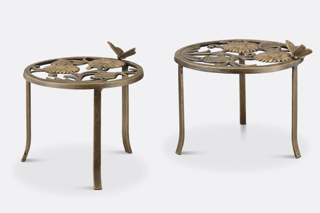 Cast aluminum plant stands, one is slightly taller than the other. Bronze in color with removable butterfly detail.