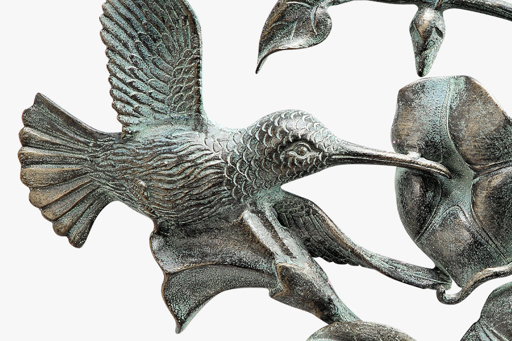 Hummingbird and Flowers Wall Plaque - detail view of sculpted bird and blossom