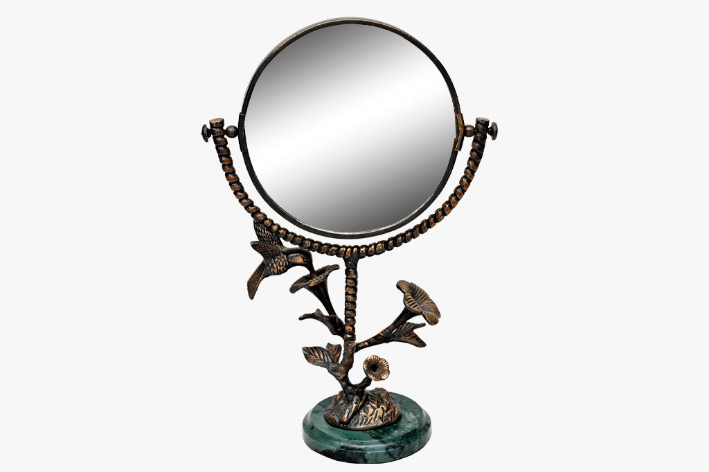 vanity mirror with marble base and stem of blossom and hummingbird motif