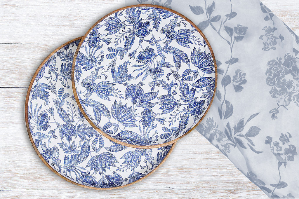 Large mango wood tray platters enameled with jeweltone blue jaquard floral print shown on wood table with floral cloth