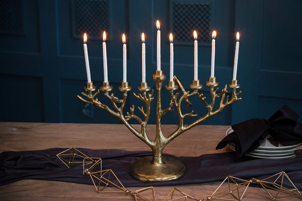 metal menorah in gold with organic branch details 