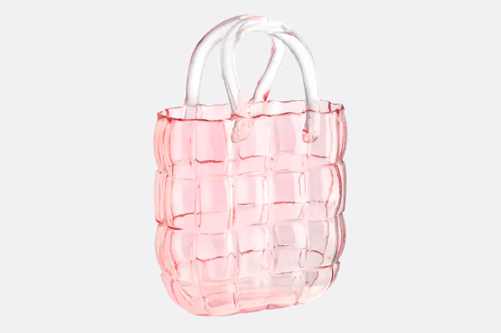 Pink glass vase shaped like handbag 