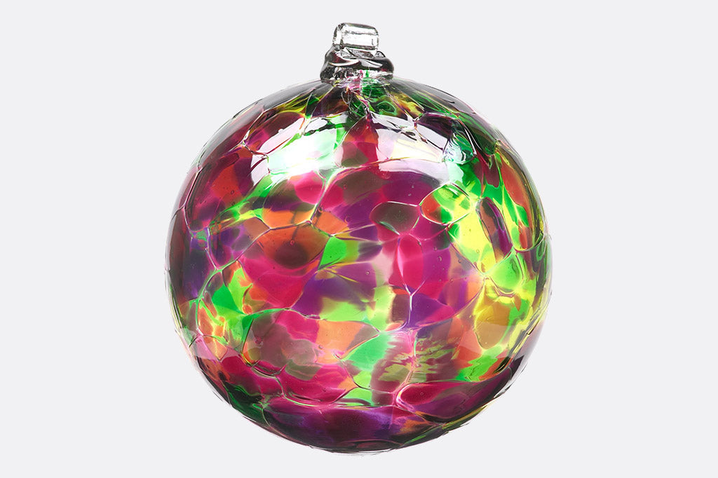 Handblown glass ornament designed to hang from metal stand