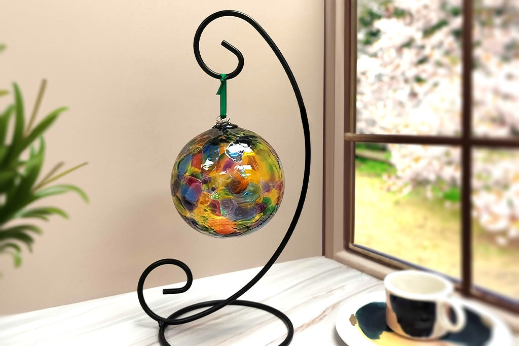 glass orb shown hanging by a kitchen window